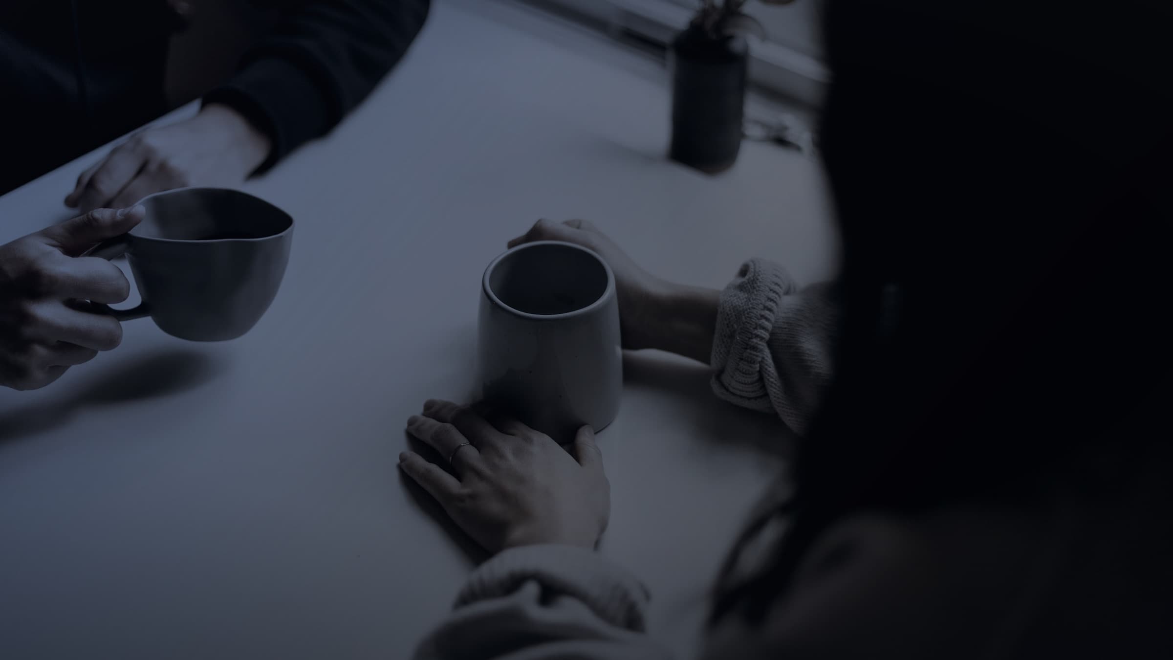 Two colleagues in a focused conversation across a table